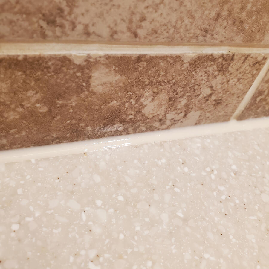 Clean new caulk for a better-looking, more water-resistant bathroom joint.